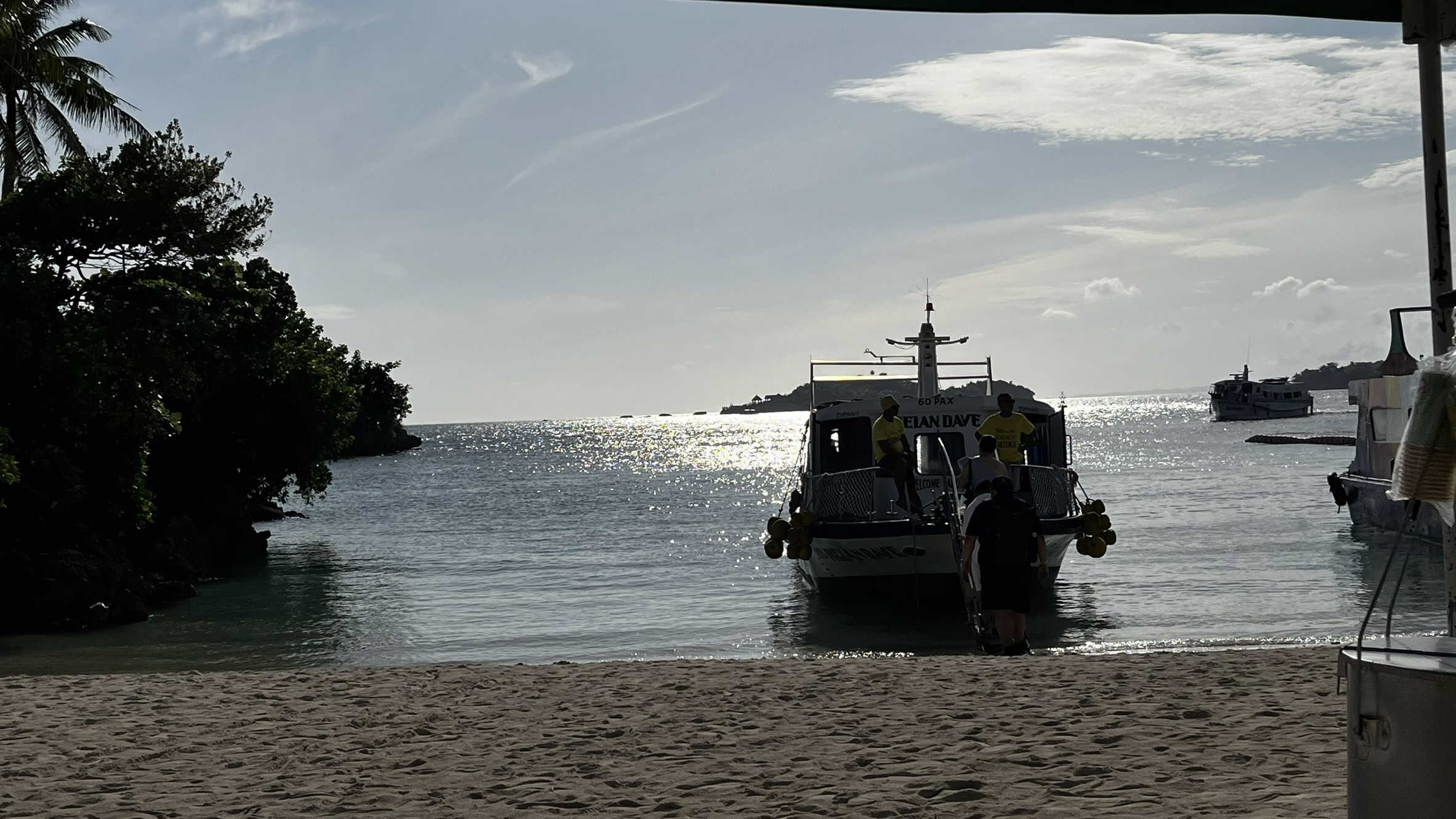 A boat rests at the beach dock in Boracay Island, surrounded by soft sand and calm waters, creating a serene coastal scene.