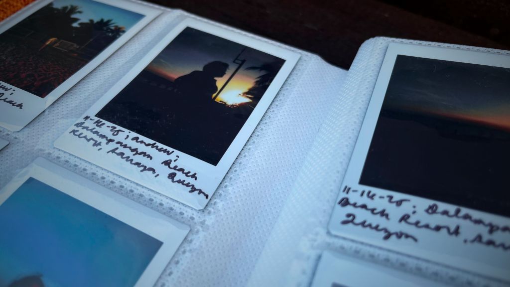 Close-up of Instax Mini instant film photos in an album, printed with the Instax Mini Evo
