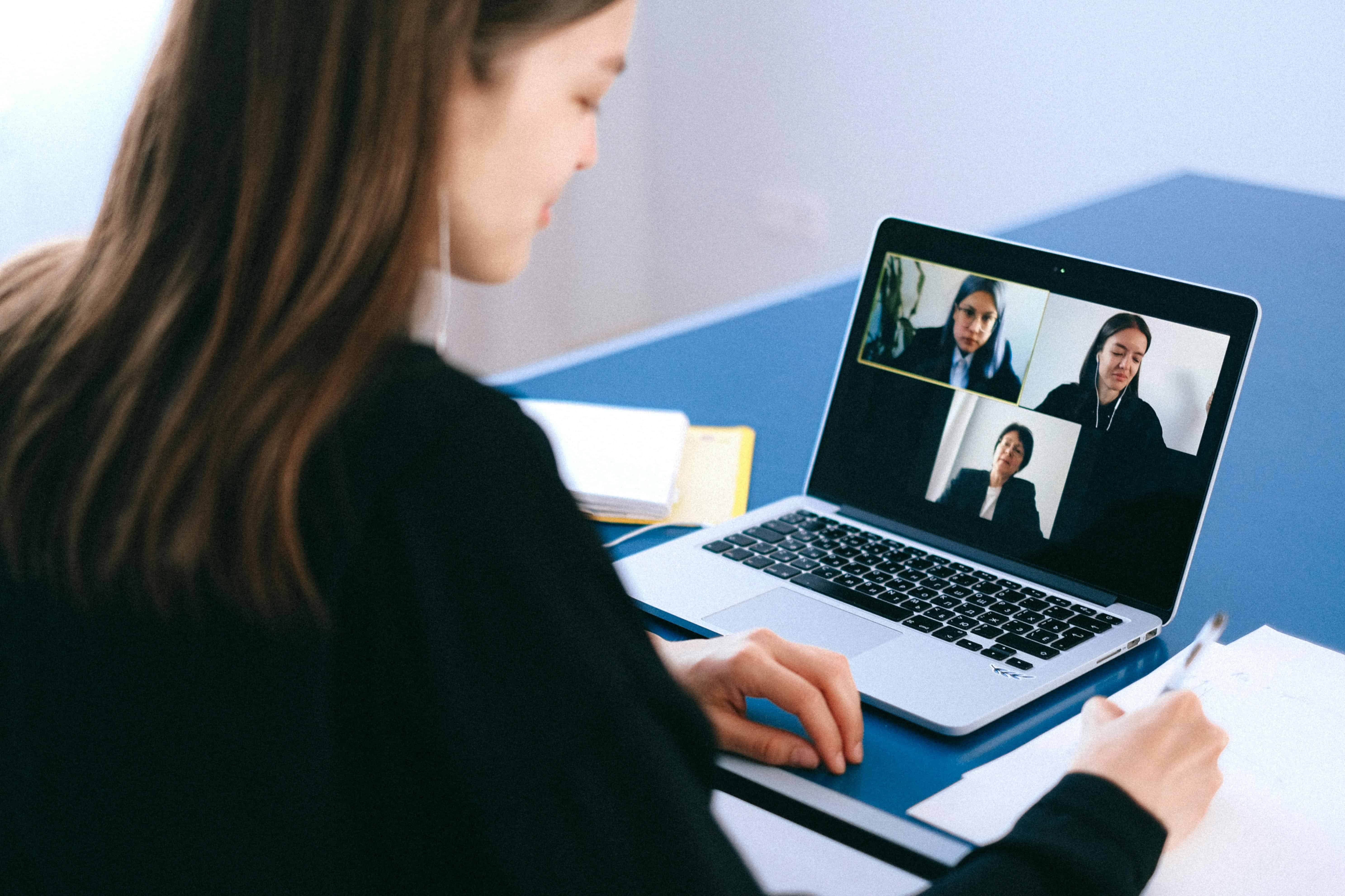 Person attending a virtual work meeting on a laptop, reflecting remote work and modern career instability.