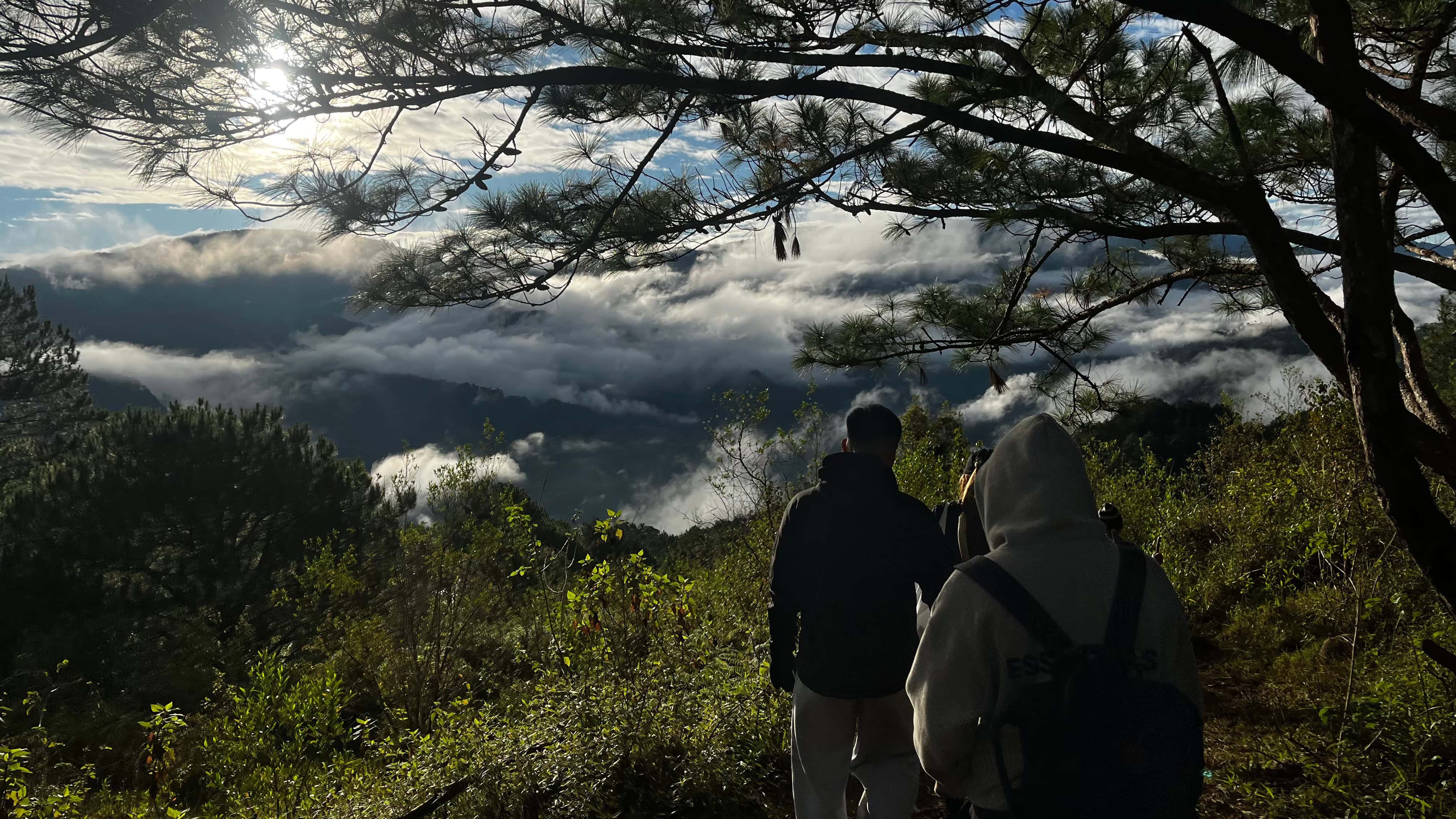 Hikers descending from Marlboro Hills with a sea of clouds view in Sagada